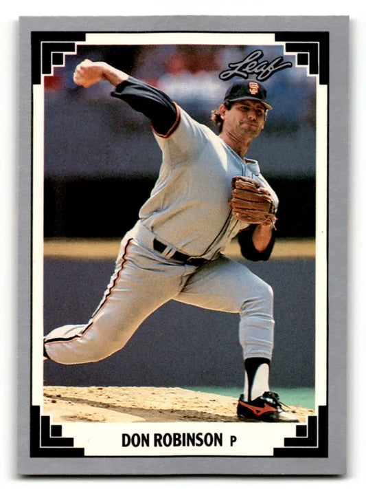 Baseball pitcher Don Robinson in white uniform delivering on San Francisco Giants card