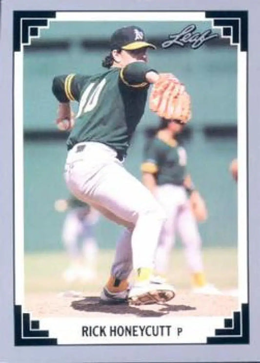 Rick Honeycutt mid-delivery in green jersey on 1991 Oakland Athletics baseball card