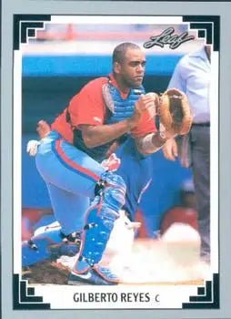 Baseball card of Gilberto Reyes in red and blue uniform for Montreal Expos making a play
