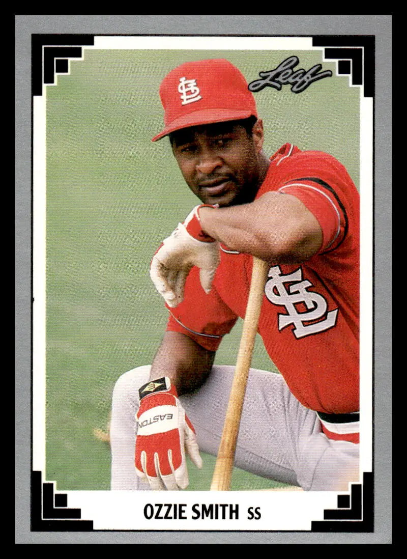 Ozzie Smith in red uniform with bat on 1991 Leaf St. Louis Cardinals baseball card