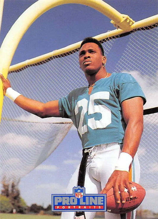 Louis Oliver in teal jersey #25 holding football under goal post Miami Dolphins Football Card