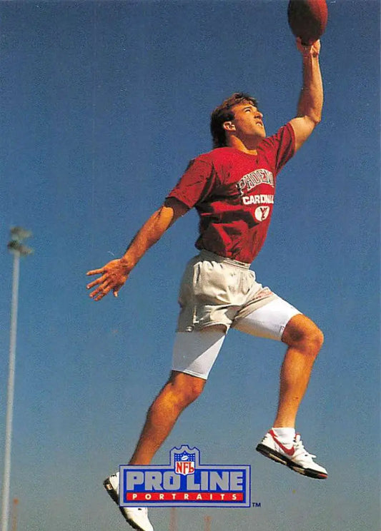 Ricky Proehl in a red jersey leaps to catch a ball for the Phoenix Cardinals