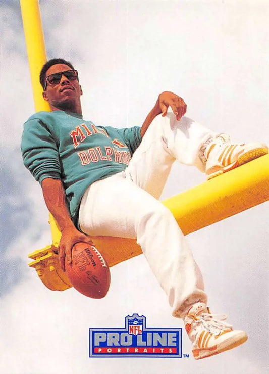 Mark Clayton in Miami Dolphins gear lounging on yellow pole for football card promotion