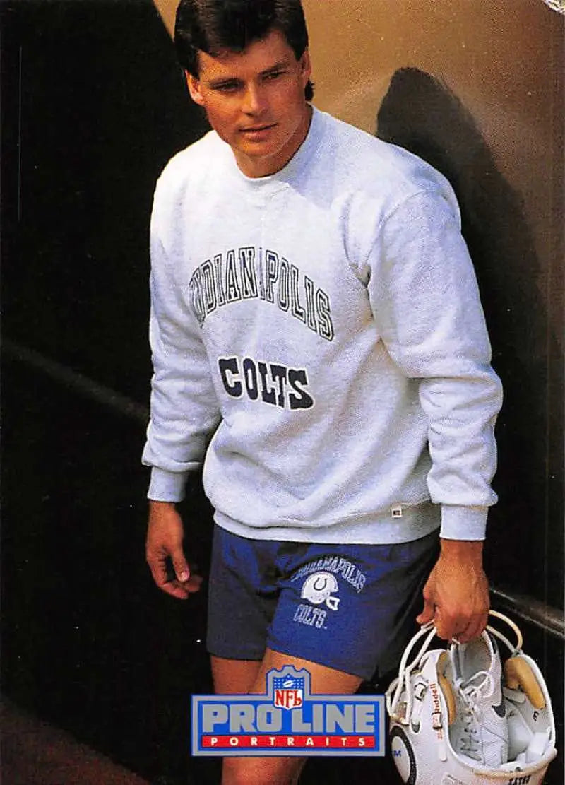 Person in Indianapolis Colts sweatshirt and shorts holding shoes, featuring Rohn Stark