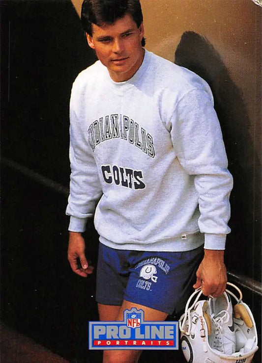Person in Indianapolis Colts sweatshirt and shorts holding shoes, featuring Rohn Stark