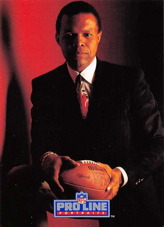 Professional football player in business suit holding NFL ball from Gale Sayers Pro Line Portraits