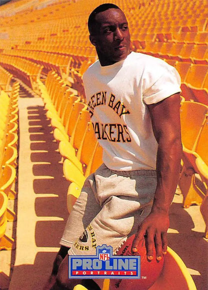 Person in Green Bay Packers t-shirt, light pants, showcasing Vinnie Clark rookie card