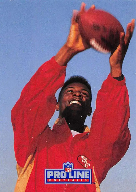 Football player in red jersey catching ball under blue sky on Jerry Rice Football Card