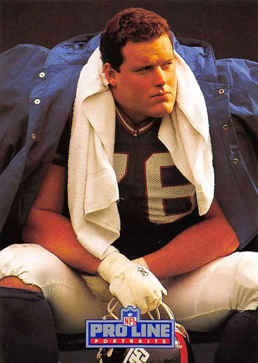 Football player in dark jersey with towel, featured in Pro Line Portraits Jumbo Elliott card