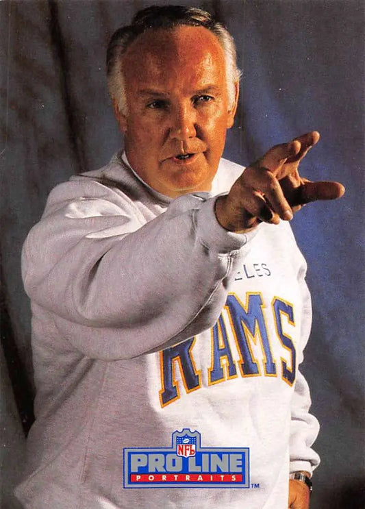 Person in white Rams sweatshirt pointing at camera near John Robinson Pro Line Portraits card
