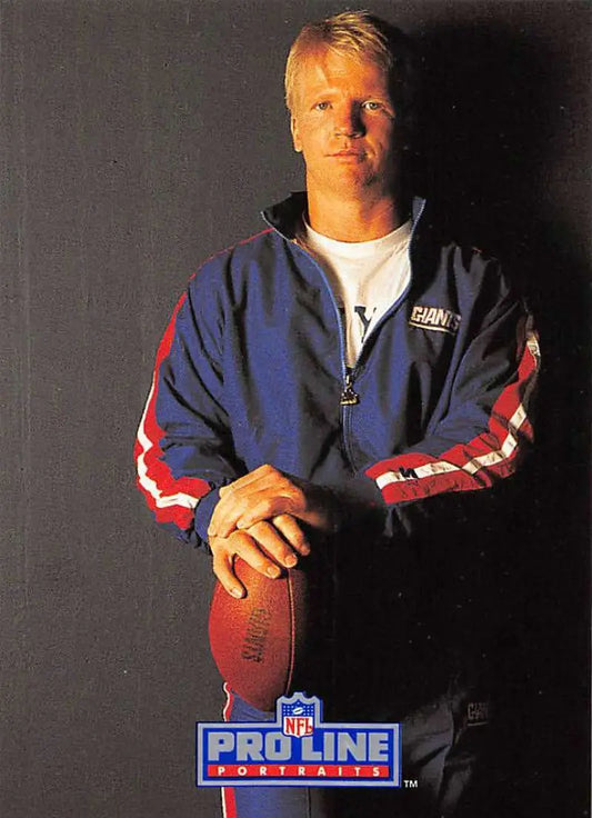 Phil Simms in blue and red jacket holding football from Pro Line Portraits collection