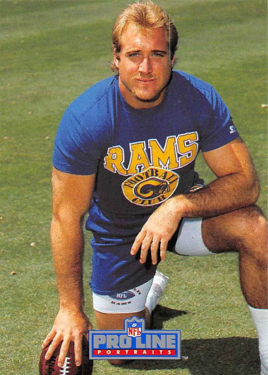 Football player in blue Rams t-shirt kneeling with football, inspired by Kevin Greene Pro Line