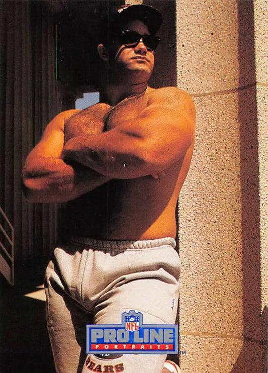 Muscular person in sunglasses and cap showcasing Chris Zorich Chicago Bears football card