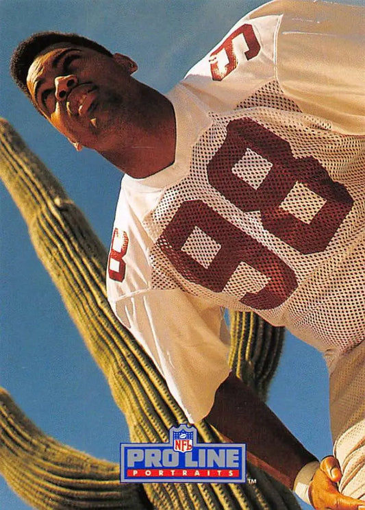 NFL player in white jersey 88 under blue sky with cactus on Eric Swann football card
