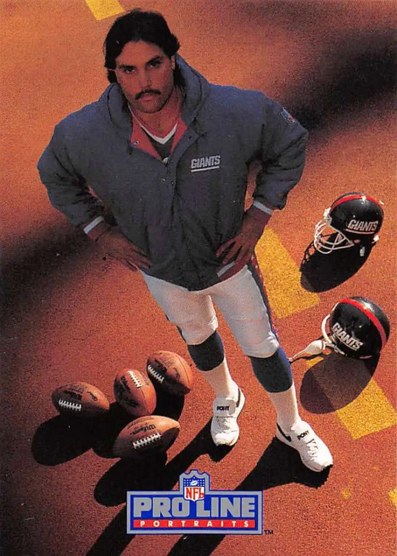 Sean Landeta in gray jacket with footballs and helmets for New York Giants Pro Line Portraits