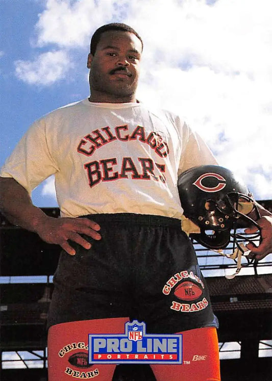 Person in Chicago Bears t-shirt holding a football helmet, featuring Mike Singletary