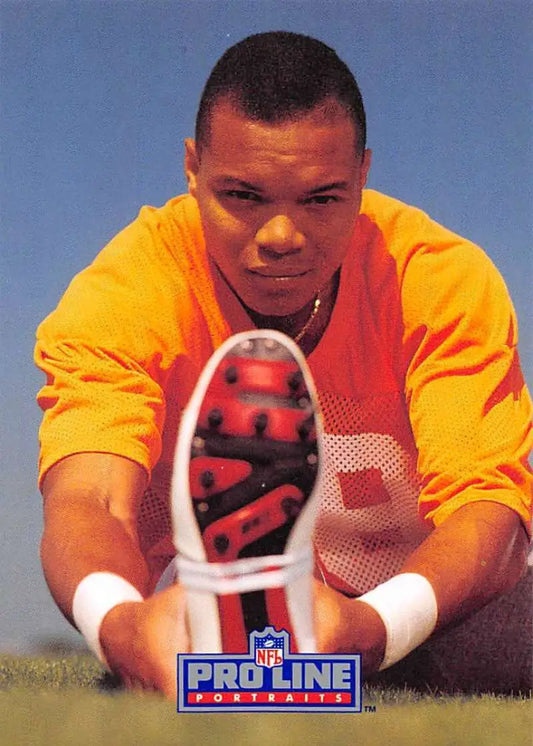 Person in a yellow sweatshirt stretching, representing Mark Carrier of the Tampa Bay Buccaneers
