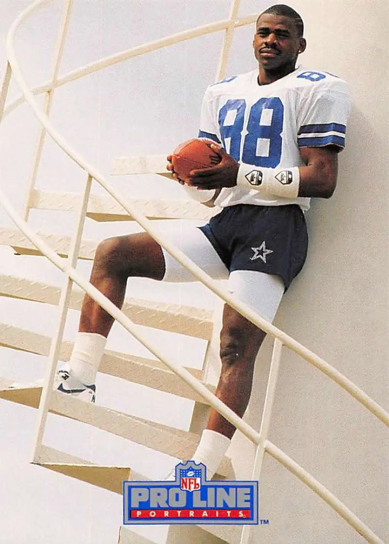 Michael Irvin in a Dallas Cowboys #88 jersey holding a football for a football card