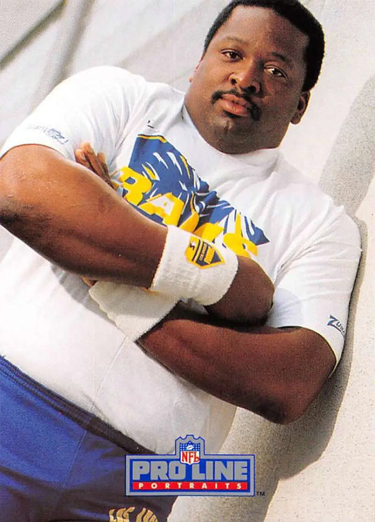 Person in white t-shirt with blue and yellow graphics posing, Irv Pankey Los Angeles Rams