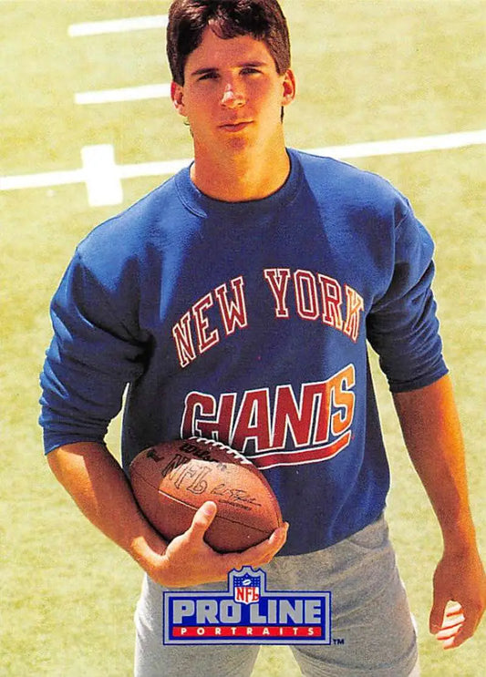Football player in blue New York Giants sweatshirt holding football for Pro Line Portraits card