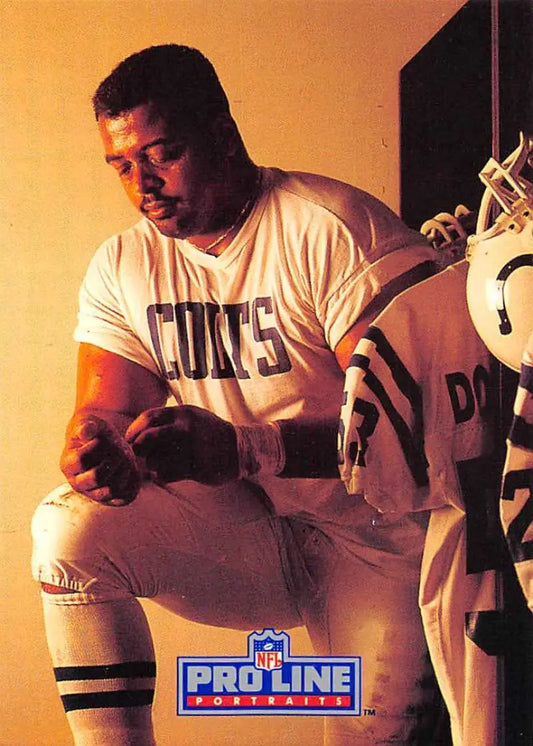 Football player in white CANES t-shirt in locker room, featured in Pro Line Portraits