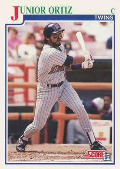 Junior Ortiz at bat for the Minnesota Twins in a pinstriped uniform baseball card