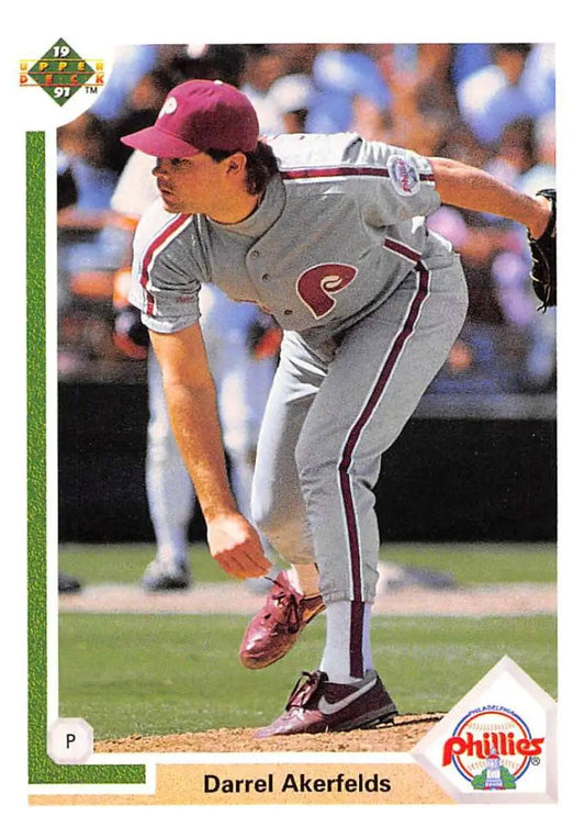 Baseball player Darrel Akerfelds in Phillies baseball uniform mid-pitch delivery