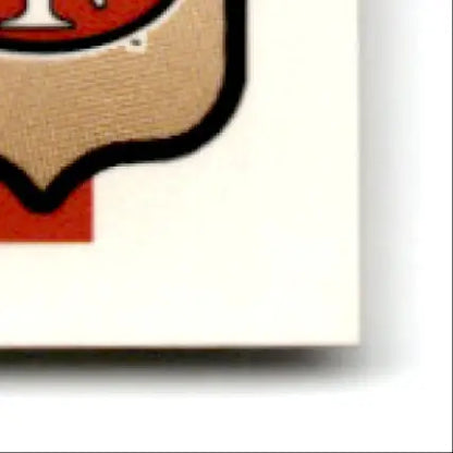 Beige and red shield-shaped emblem with black outline from Fleer Football Steve Young card