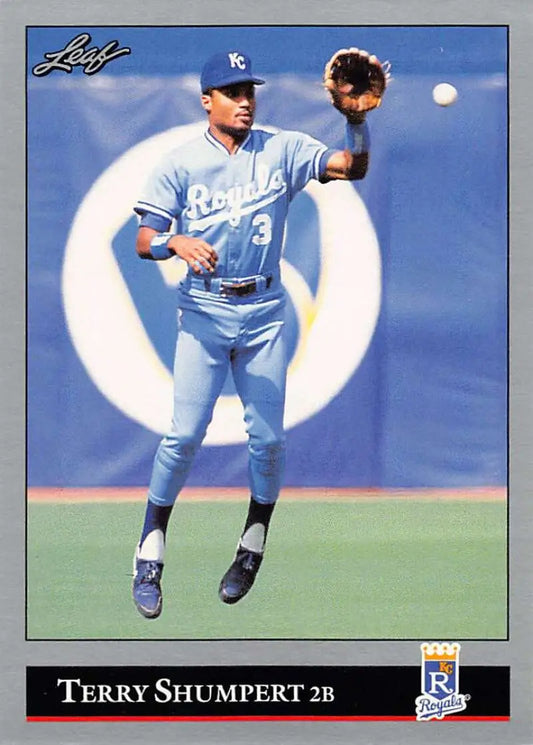 Kansas City Royals player Terry Shumpert leaps to catch a ball in light blue uniform