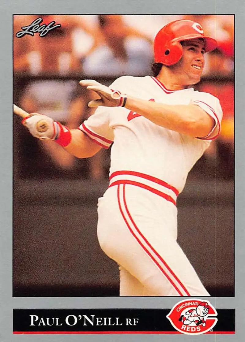 Baseball card of Paul O’Neill swinging for the Cincinnati Reds in white and red uniform