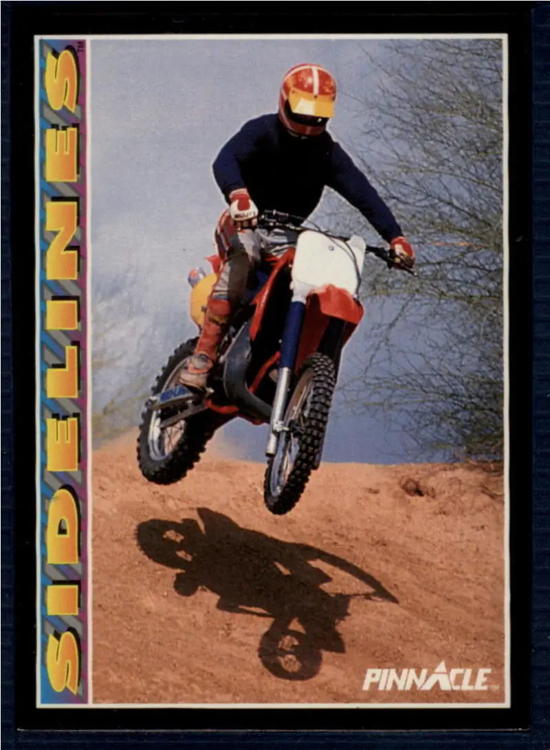 Dirt bike rider jumping on motorcycle with 1992 Robin Yount Baseball Card in background