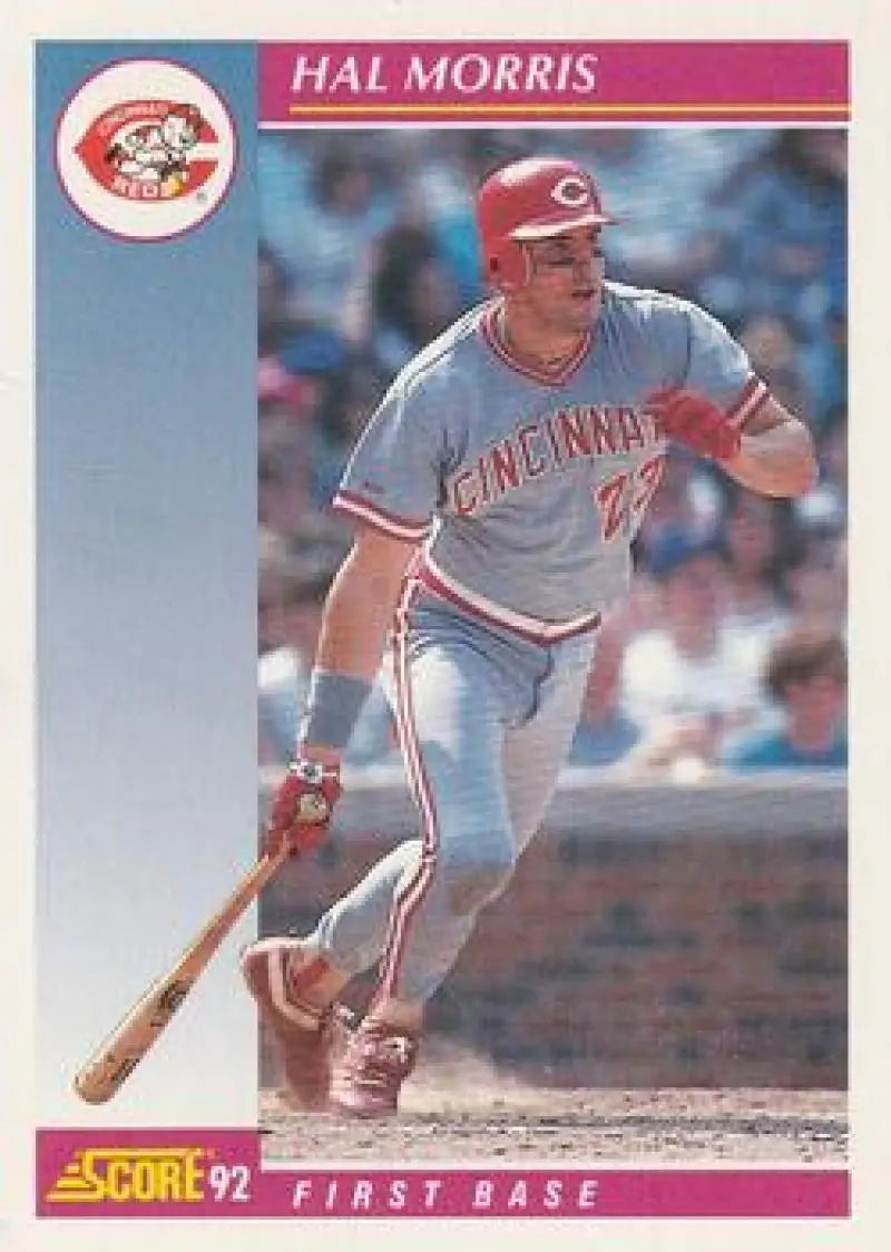 Hal Morris of the Cincinnati Reds swinging at home plate in his grey uniform