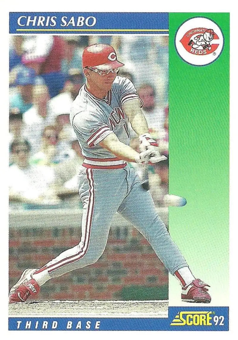 Cincinnati Reds baseball player Chris Sabo swinging bat in grey uniform with red trim