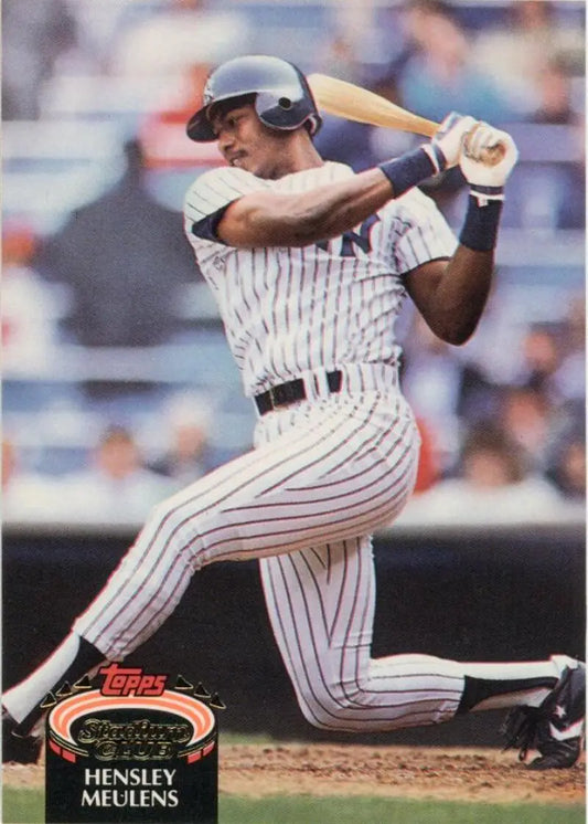 Baseball player in New York Yankees uniform swinging bat on Topps Stadium Club card