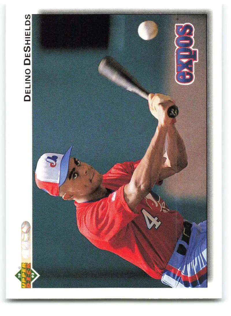 Delino DeShields in a red jersey swinging a bat for Montreal Expos baseball card
