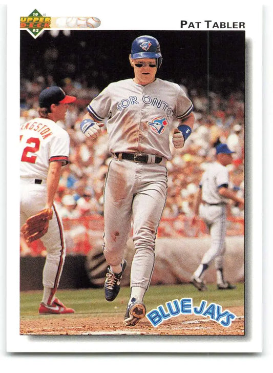 Baseball player Pat Tabler in Toronto Blue Jays uniform running past first base