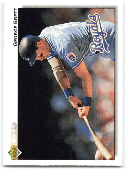 Baseball player George Brett in Kansas City Royals uniform leaning over bat