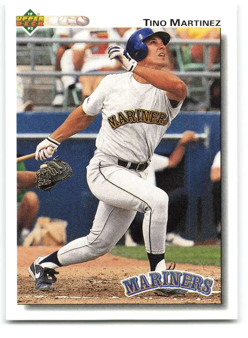 Baseball card of Tino Martinez swinging in white uniform for Seattle Mariners