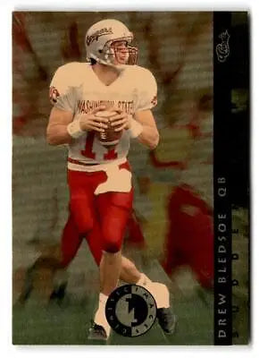 Drew Bledsoe in white jersey and red pants dropping back to pass from Classic Images Four Sport