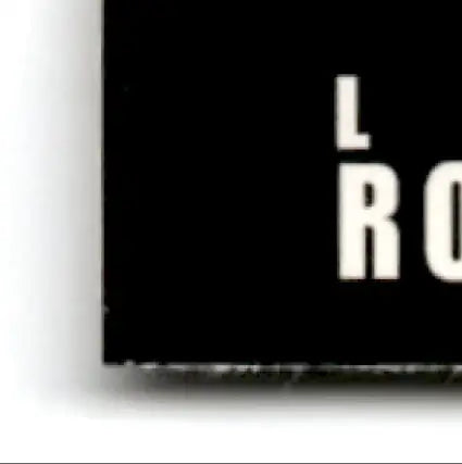 Black rectangular sign with white text displaying lro assistant from 1993-94 Upper Deck Hockey Luc Robitaille #293