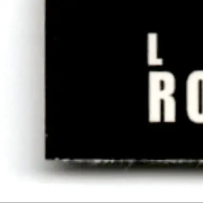 Black rectangular sign with white text displaying lro assistant from 1993-94 Upper Deck Hockey Luc Robitaille #293