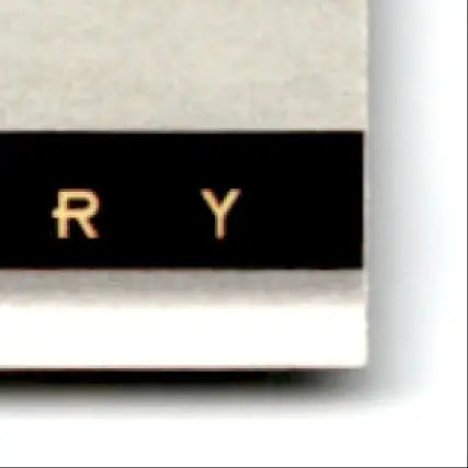 Black rectangular sticker with gold letters r y on white surface for 1993-94 Upper Deck Hockey Theoren Fleury rookie card