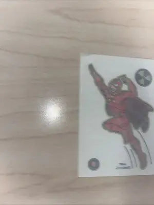 Red superhero sticker featuring Radioactive Man from Bongo Comics trading card collection