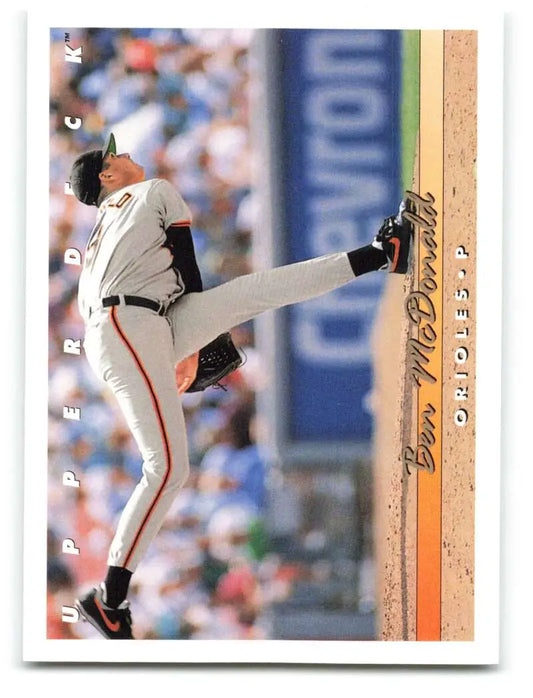 Ben McDonald delivering a pitch in black and white uniform on baseball card