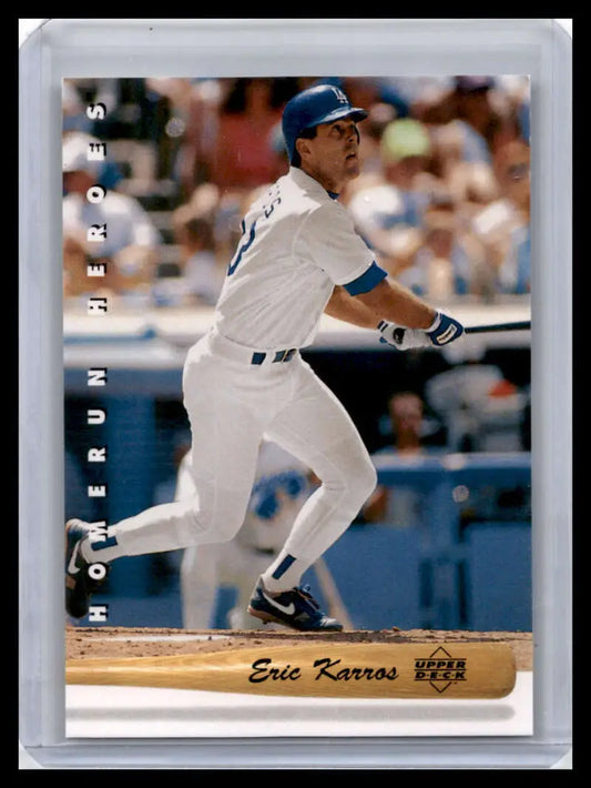 Baseball player Eric Karros swinging in a white uniform for the Los Angeles Dodgers