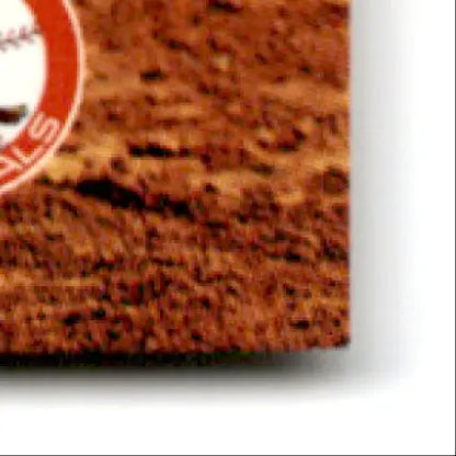 Baseball field dirt with part of a baseball logo from 1994 Classic Baseball Alan Benes St. Petersburg Cardinals