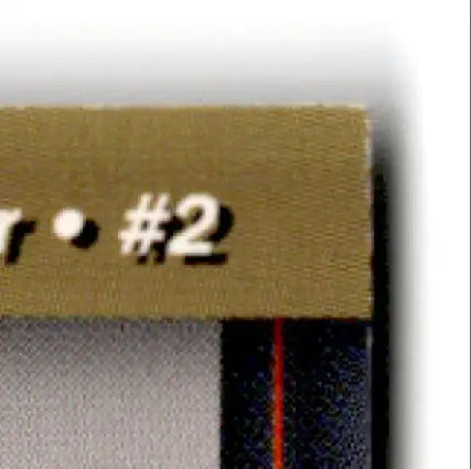 Gold-colored card corner with red stripe and number 2 from 1994 Pro Set Power Racing Roger Penske