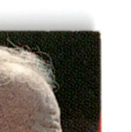 Top left of human head with white hair from 1994 Pro Set Power Racing Roger Penske #107