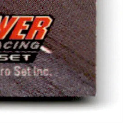 Part of a packaged 1994 Pro Set Power Western Auto trading card with textured dark gray surface