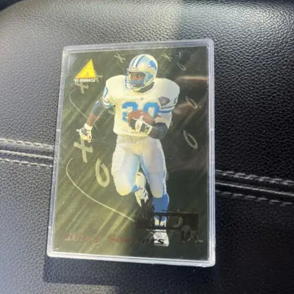 Football trading card in protective case featuring Barry Sanders NFL Detroit Lions